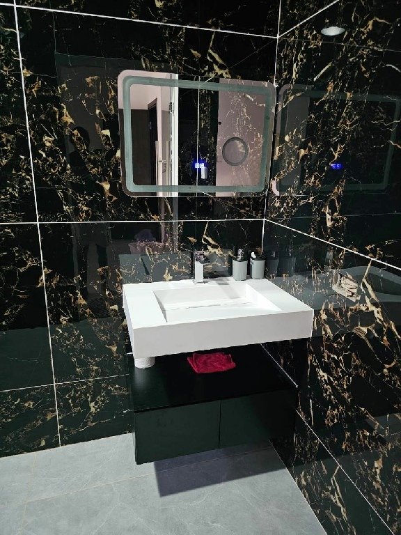 modern bathroom design with white sink & black vanity~1
